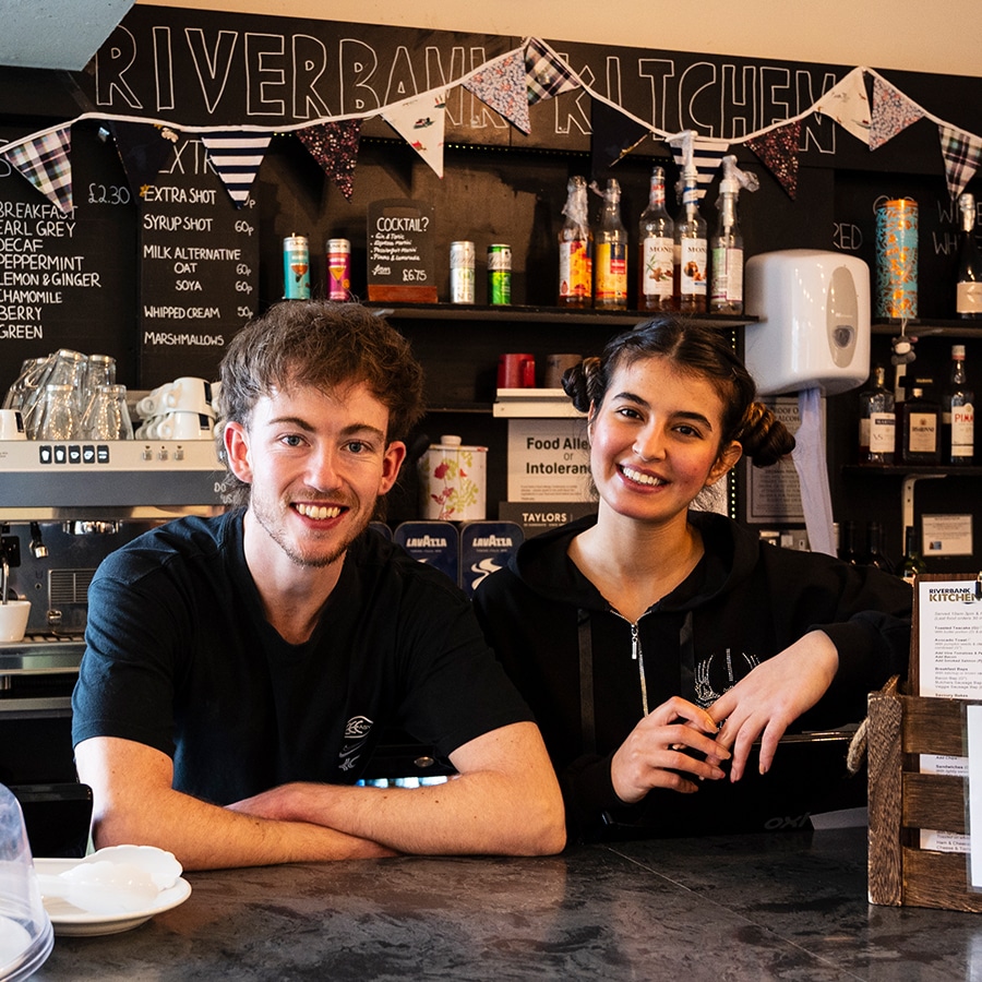 Two young people working in the café at the Yvonne Arnaud Theatre