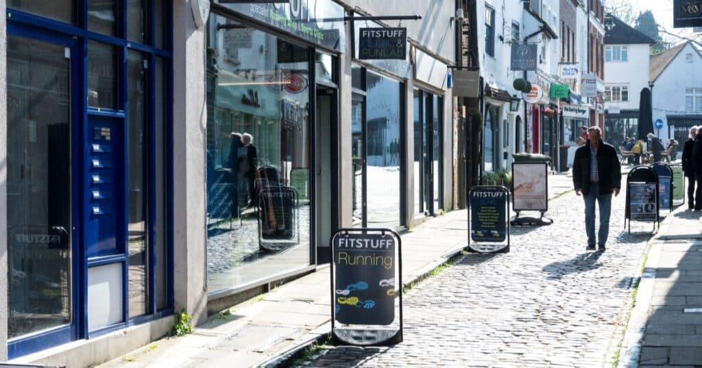 A series of shops bordering a cobbled street in Guildford, Surrey