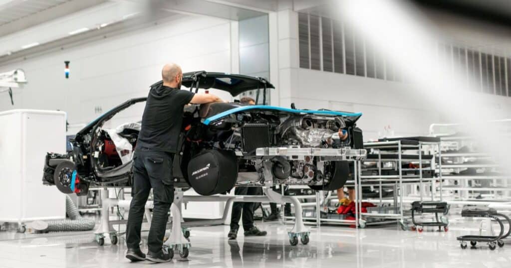 A skilled worker assembles a McLaren supercar at the line in Woking, Surrey