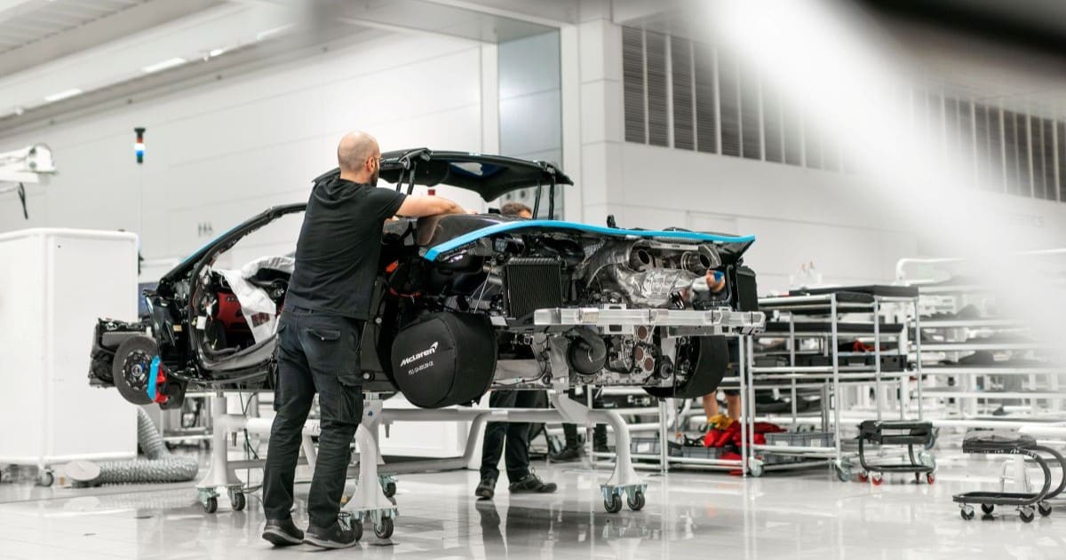 A skilled worker assembles a McLaren supercar at the line in Woking, Surrey