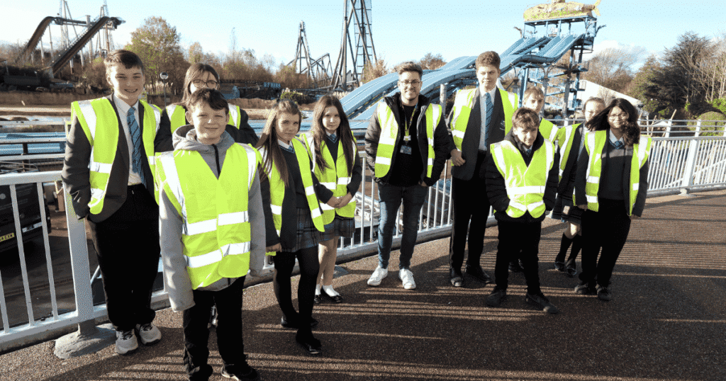 A group of students wear high vis jackets on their visit to Thorpe Park as part of their work experience. | Surrey Careers Hub | Business Surrey | Future workforce development